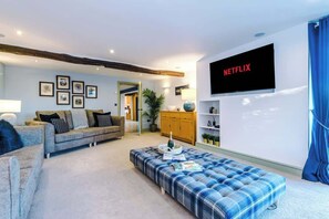 The spacious living room benefits from a 55-inch SMART TV with Netflix on the wall, plenty of space to sit down with family and friends in the evening, and a gorgeous log burner to keep warm in the evenings.