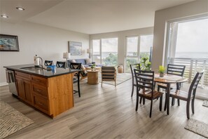[Living Room] Beautifully Lit with Natural Light, the Open-Concept Living Room is Perfect for Gathering After a Day at the Beach.