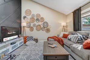 Welcome to our lovely home! This is our living room. Stream all of your favorite shows on the TV while relaxing on the plush couch!