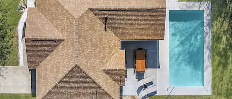 Aerial view of our home, backyard and blue swimming pool 