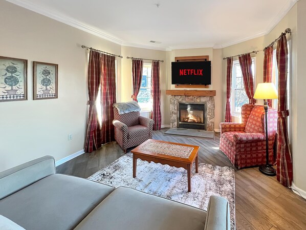 Living area with a gas fireplace and LCD Roku TV