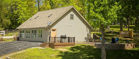 A cozy house with a driveway and a yard, perfect for a small family or someone seeking tranquility.