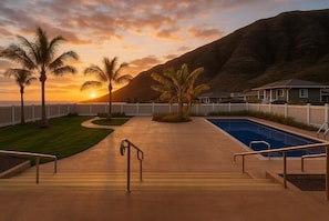 Watch the sunset poolside beneath golden skies (Available late May 2025)