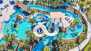 Thrilling water park with twisting slides, a lazy river, palm trees, and plenty of sun-soaked fun!
