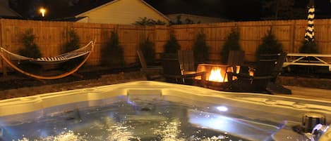 Dreamy backyard space! Enjoy the year round hot tub, fire pit, picnic area, hammock, and gas grill