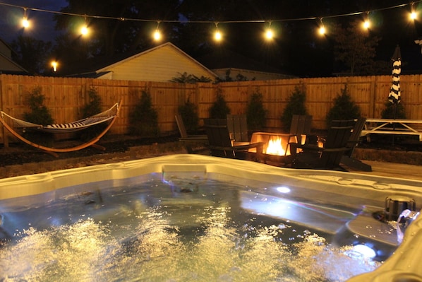 Dreamy backyard space! Enjoy the year round hot tub, fire pit, picnic area, hammock, and gas grill