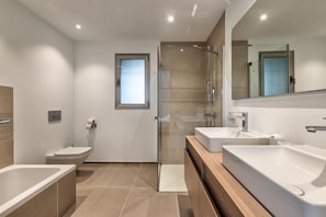 Main bathroom with bathtub and shower