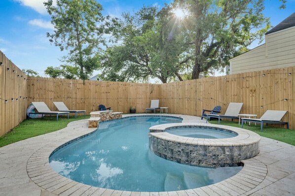Beautiful outdoor pool w/ separate hot tub, back yard w/ artificial turf, outdoor seating, and bbq grill