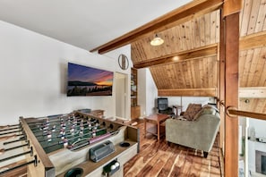 The loft features a foosball table and large TV
