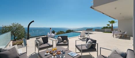 One of the many lounge spaces on the 150 m2 pool terraces overlooking the Adriatic sea and the Dalmatian archipelago. This particular lounge area for 10 is now shaded by a pergola.