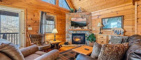 Cozy living room area with fireplace, Smart TV and comfortable seating for the entire group.
