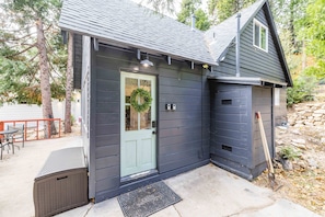 Follow the porch to your cozy cabin nestled among the trees. #Getaway #NatureLover. Our front door awaits on the right side of the cabin. 