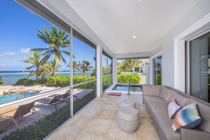 Screened porch is also furnished with an outdoor sofa and spa.