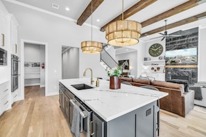 The Stonefront's kitchen and living space looking at entry hall and hallway to private garage