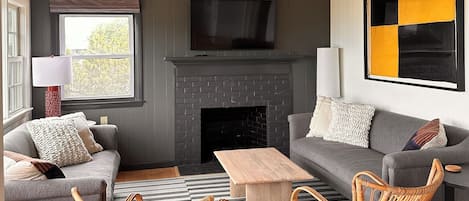 Living room with fireplace and beautiful view of the bay.