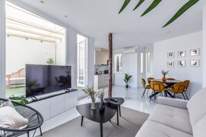 View of living room space with the background and dining room and kitchen space