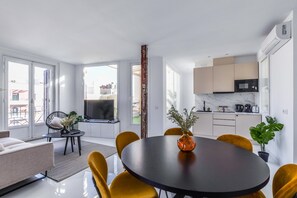 View of living room space with the background and dining room and kitchen space