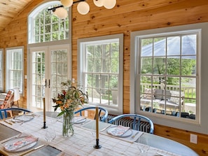 The wrap-around windows have a direct view to the deck, backyard, and of course, the river.