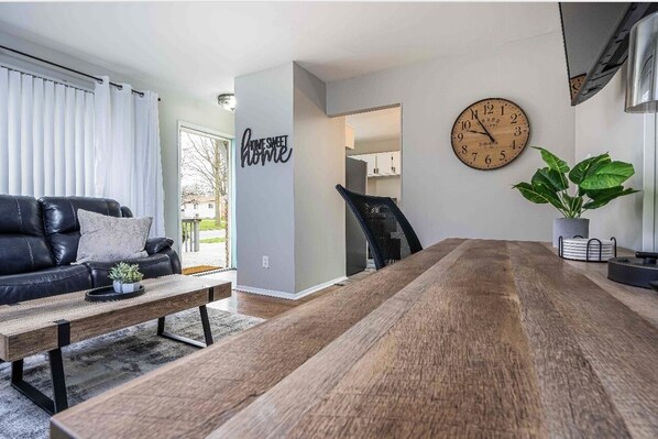 Front entrance to the house. 
Living room with workspace and 65" Roku Tv 