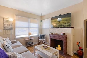 Enjoy your favorite movie on our 55 inch Roku TV. Turn on the candles for ambiance in the original fireplace.