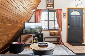 Livingroom smart tv and window with a view of Ponderosa Pine trees.