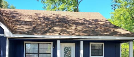 Front of home. Front porch sitting area. Private entry from driveway on right.