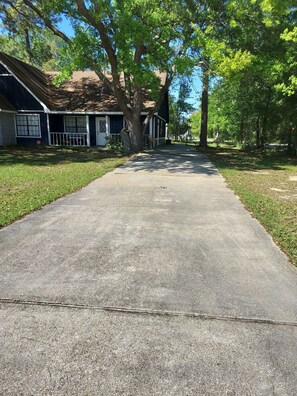Long paved driveway on right side of house.