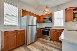 Kitchen with full size refrigerator and freezor.