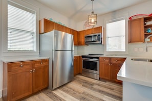 Kitchen with full size refrigerator and freezor.