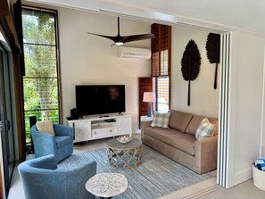 Living room with pull out sofa and sliding doors for privacy
