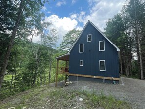 North side of house, showing the slope down to the river 