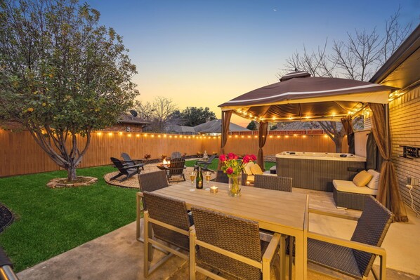 Back yard is incredible - hot tub, firepit, living & dining, waterfall... 