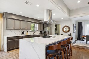 Giant quartz island with electric cooktop so the chef of the house can be the li