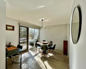 Dining room and dedicated workspace with slide doors accessing the second patio
