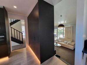 Open-plan contemporary living  with good flow, high ceilings, and mood lighting 