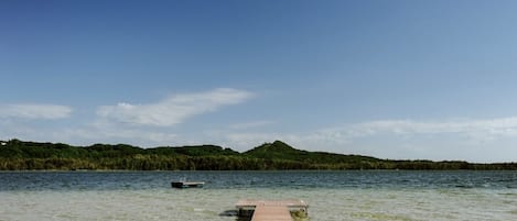 Beachside view of Little Traverse Lake and Sugar Loaf Mountain.