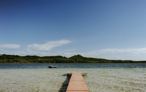 Beachside view of Little Traverse Lake and Sugar Loaf Mountain.