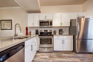 Large remodeled kitchen with quartz counter tops and tile flooring