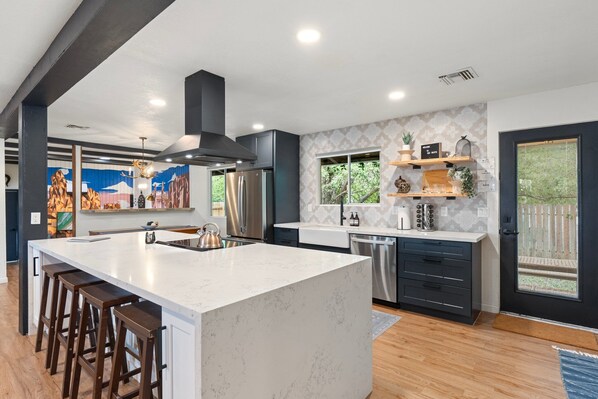 Open concept, renovated kitchen fully stocked with luxury appliances.