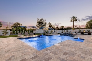 Stunning resort-style spacious yard featuring Heated Pool and Spa, Sun Loungers, Firepit, Putting Green, Ping Pong, Cornhole and ample yard space.