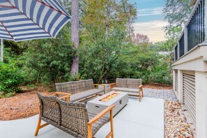 Backyard oasis features a firepit and pool.