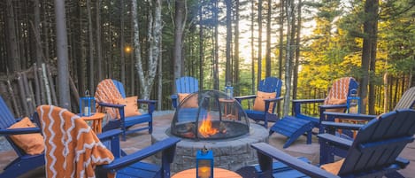 Vibrant firepit area with a canopy of string lights: roast smores on the fire!