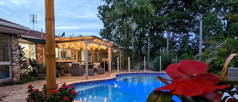 Swimming pool at dusk overlooking the golf course