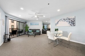 Open concept living room with balcony with ocean view