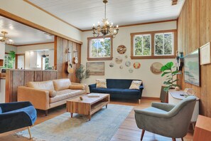 Living room with West Elm leather couch, velvet sofa, solid wood coffee table