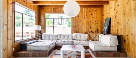 Vintage wood panel sunroom. The built in couch is perfect for playing boardgames or extended conversation.