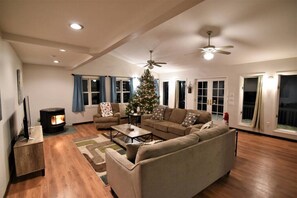 Living room with festive decorations and cozy pellet stove