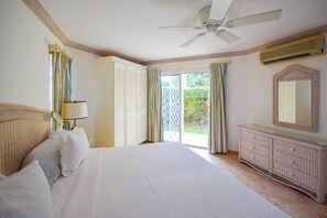 The spacious master bedroom has their own little patio and door opening to the garden