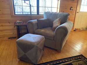 Comfy chair and ottoman in main floor living area.  