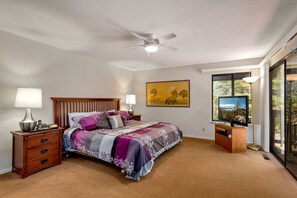 Another view of the primary bedroom, offering a cozy retreat with scenic views